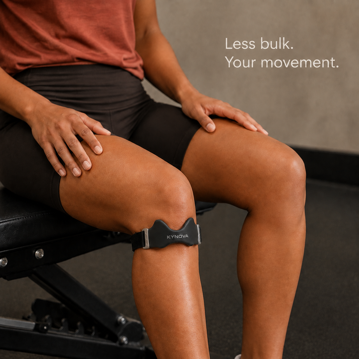 Woman seated with the Kynova strap below her kneecap